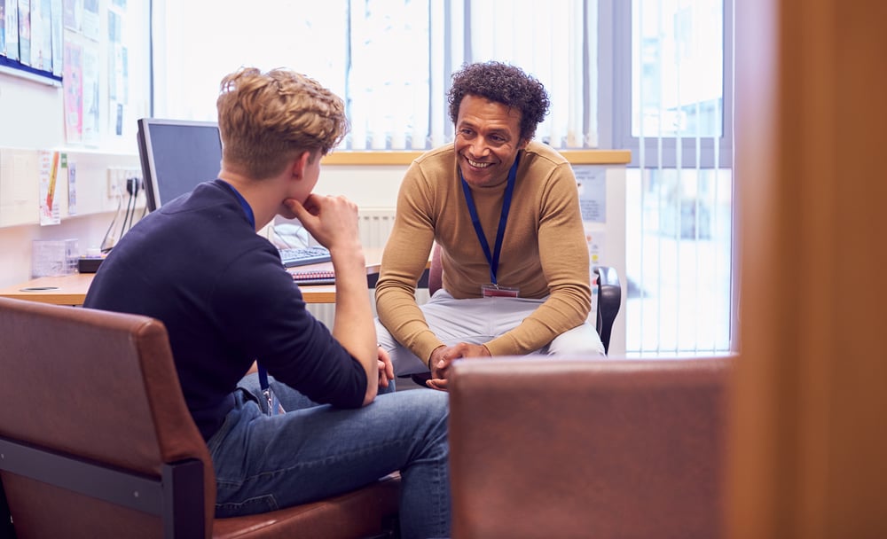 Photo of two professionals within a school setting having a meeting 