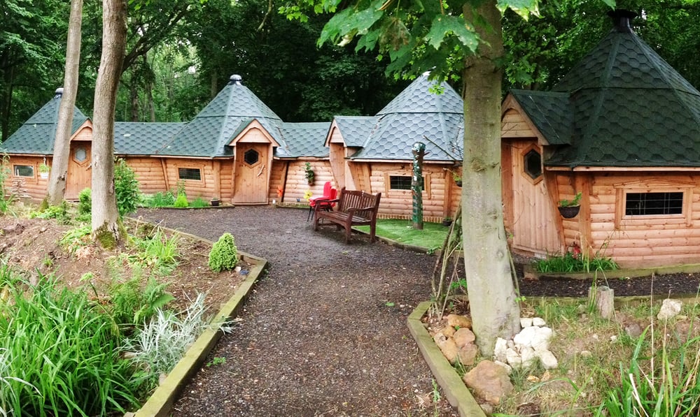 Series of connected Scandinavian forest school cabins in woodland location