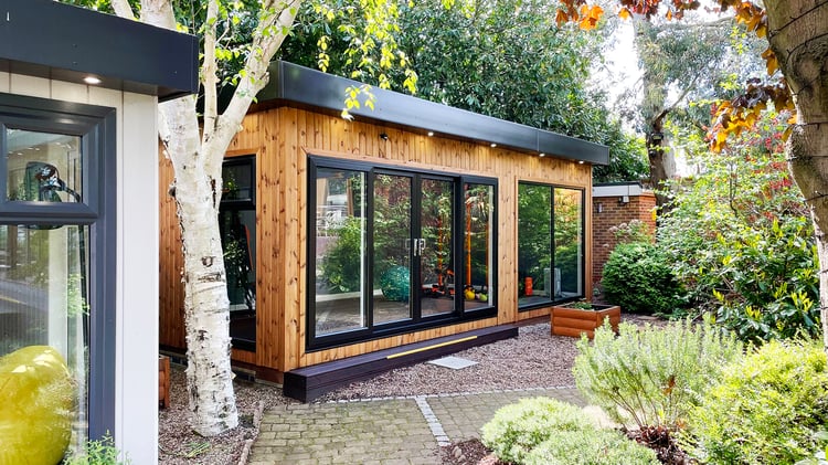 External shot of a redwood clad school cabin