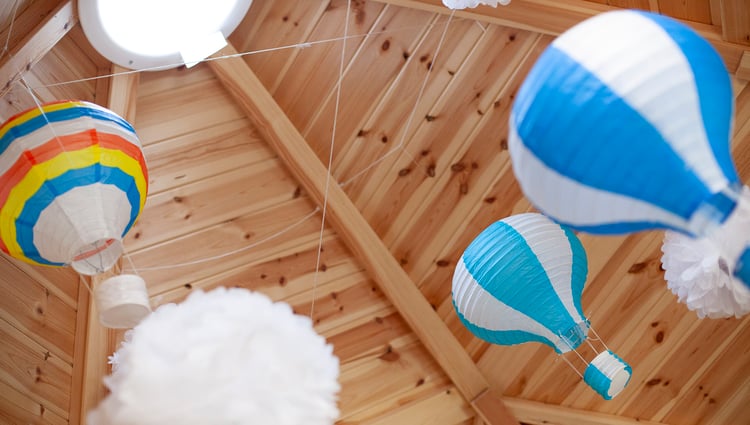 Shot showing the ceiling and hanging decorations inside a scandi school cabin