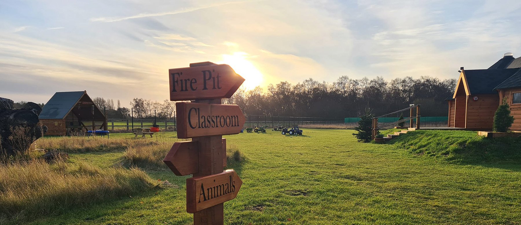 Countryside eco nursery with wooden signs in foreground