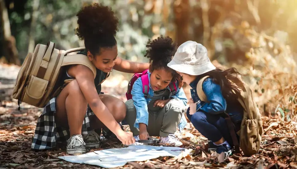 kids-checking-map-in-wood